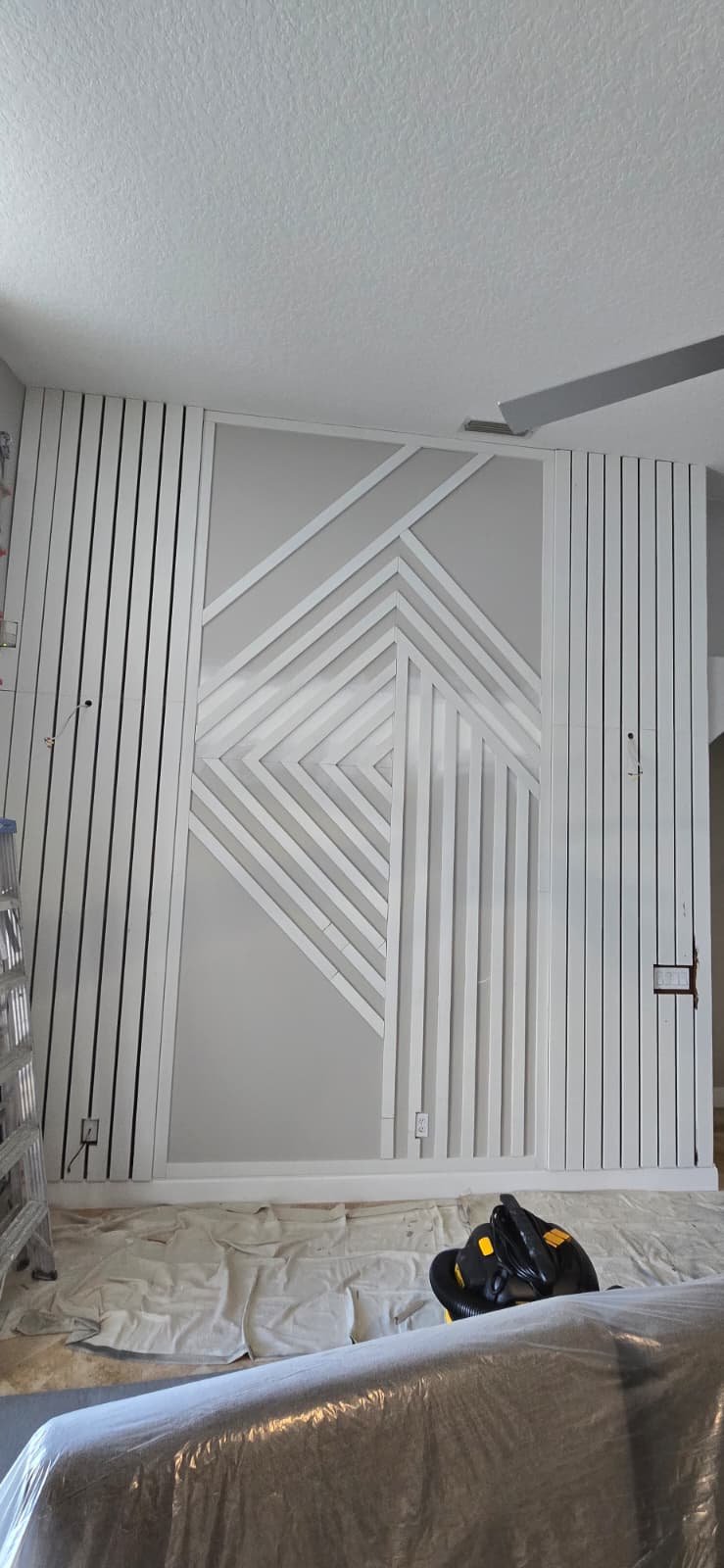 White geometric slat accent wall in progress